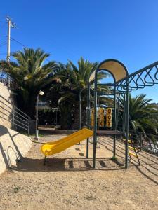 a playground with a yellow slide in a park at Vista Bahía Puerto Valparaíso - Depto entero 2 Dormitorios in Valparaíso