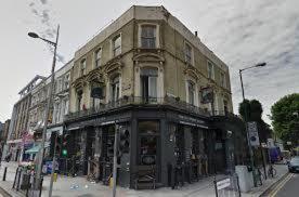 a building on the corner of a street at 118 Brondesbury Road Apartments in London