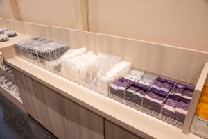a shelf in a store filled with lots of products at Sanco Inn Nagoya Nishiki Shikinoyu in Nagoya