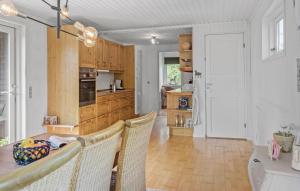 a kitchen and dining room with a table and chairs at Awesome Home In Gedser With Wifi in Gedser