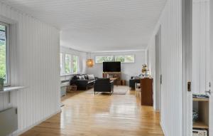 a living room with white walls and a hard wood floor at Awesome Home In Gedser With Wifi in Gedser +10 photos