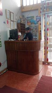 a man sitting at a counter in a store at HOSTAL ACUARIUS PUNO in Puno