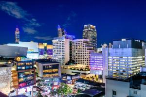 a city skyline at night with many tall buildings at Novotel Bangkok on Siam Square in Bangkok