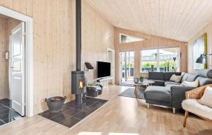 a living room with a couch and a fireplace at Nice Home In Tarm With Sauna in Tarm