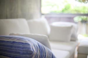 a couch and a chair in a living room at ONJUKU BEACH HOUSE - private villa 1 min walk to beach with sea view in Onjuku