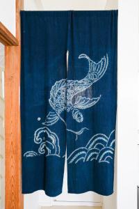 a blue curtain with a white bird painted on it at ONJUKU BEACH HOUSE - private villa 1 min walk to beach with sea view in Onjuku