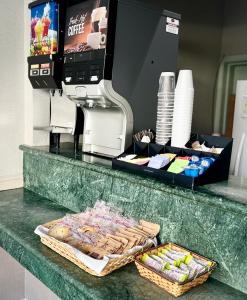 a counter with a coffee machine and a tray of food at City Center Inn and Suites in San Francisco