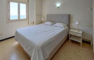 a white bedroom with a large bed and a window at Cozy Apartment In Fuengirola With Wifi in Fuengirola