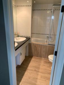 a bathroom with a sink and a tub and a toilet at Durbuy Dream in Durbuy +52 photos