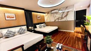 a hotel room with two beds in a room at Rosa Hotel & Spa in Ho Chi Minh City +38 photos