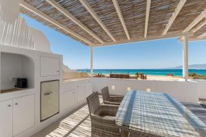 a kitchen with a table and a view of the beach at Deco Suites in Naxos Chora