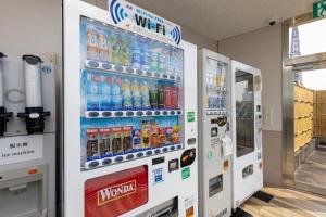 a vending machine filled with bottles of soda at Sanco Inn Nagoya Nishiki Shikinoyu in Nagoya