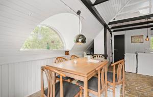 a dining room with a wooden table and chairs at 3 Bedroom Lovely Home In Hemmet in Hemmet