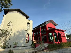 a red and white building next to a building at T terrest Residence in Thai Muang