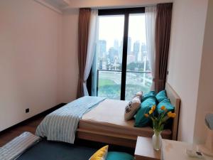 een slaapkamer met een bed met een groot raam bij OPUS RESIDENCE KL I HomeBrickz in Kuala Lumpur