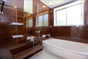 une salle de bain avec une baignoire et une fenêtre dans l'établissement スターダストヴィラミルキーウェイ, à Fukai 20 autres photos