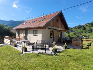 a house with a patio and a fence at A l'air de Storck - Gîte de montagne 4 étoiles 6-8 personnes in Storckensohn