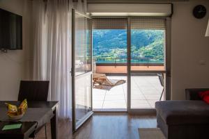 a living room with a view of a balcony at Casa vacanze Filos in Pergine Valsugana
