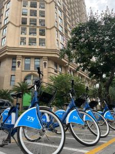 a row of blue bikes parked in front of a building at HT Home D'el Dorado 1 in Hanoi