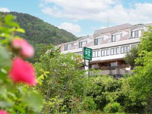 a building with a sign in front of it at Hotel Koryu in Fujikawaguchiko