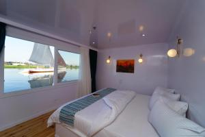 a bedroom with a bed and a large window at Turquoise in Luxor +13 photos