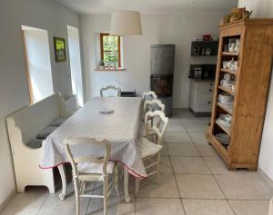 a kitchen with a table and chairs in a room at Gîte sainte Famille in Ottrott