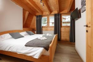 ein Schlafzimmer mit Bett und Flachbildfernseher in der Unterkunft Chalet Silvi Residence in Bormio