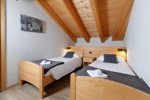 Postel nebo postele na pokoji v ubytování Chalet Silvi Residence