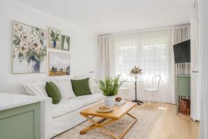 a living room with a white couch and a table at Parker Cottage in Maleny