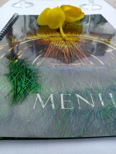 a plastic bag with grass and a yellow flower on it at Gladak di Uma Bali in Sidemen