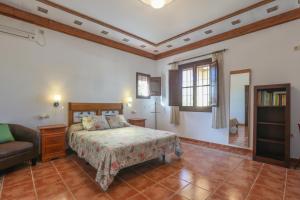 a bedroom with a bed and a couch at Casa rural Los Miradores in Marchena +42 photos
