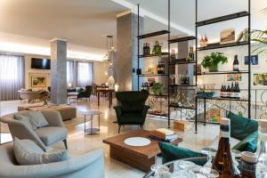 a living room with couches and chairs and tables at Palace Hotel San Pietro in Bardolino