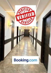 a hallway in a building with a sign that reads wanted wanted at JB Residency !! Top Rated & Most Awarded Property in Tricity !! in Chandīgarh