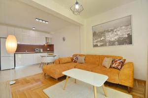 a living room with a couch and a table at Discovery Point Apartments in Tivat