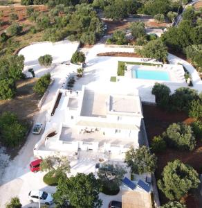 an aerial view of a large white building with a pool at Casa Vacanze 'La Quercia' in Cisternino