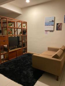 a living room with a couch and a television at Homestay Timurbay in Kuantan