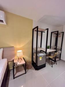 a room with a bed and a table and mirrors at Hotel Sol Caribe Cartagena in Cartagena de Indias