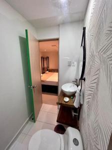 a small bathroom with a sink and a toilet at Hotel Sol Caribe Cartagena in Cartagena de Indias