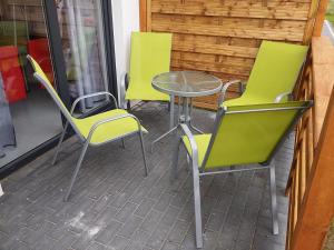 two chairs and a table and a table and chairs at Hibiskus - domki letniskowe in Jastrzębia Góra +16 photos