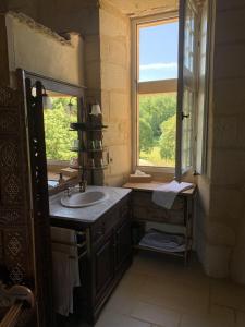 a bathroom with a sink and a window at Château de Monsac in Monsac