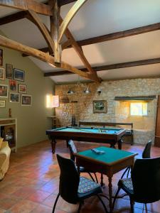 a room with a ping pong table and chairs at Château de Monsac in Monsac
