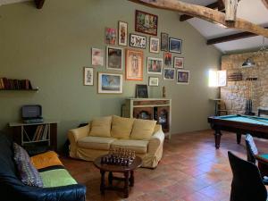a living room with a couch and a pool table at Château de Monsac in Monsac