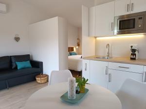 a kitchen and living room with a couch and a table at Casas Natura Suites - Finca Rural in Graus +58 photos