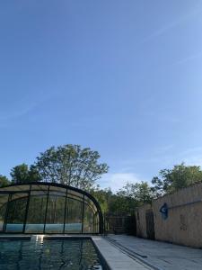 a pool of water in front of a glass building at Château de Monsac in Monsac