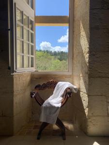 a chair in a room with a window at Château de Monsac in Monsac