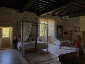 a bedroom with a bed and a living room at Château de Monsac in Monsac