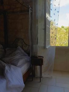 a bedroom with a bed next to a window at Château de Monsac in Monsac