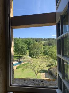 a window view of a garden from a house at Château de Monsac in Monsac