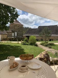 a white table with a cake on it in a yard at Château de Monsac in Monsac