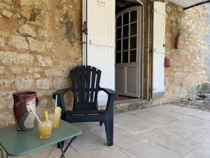 a black chair sitting on a table next to a door at Château de Monsac in Monsac